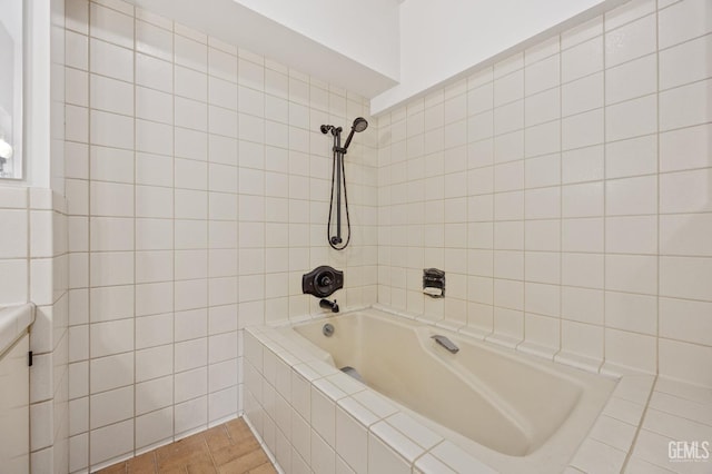 bathroom featuring tile patterned floors and tiled shower / bath combo