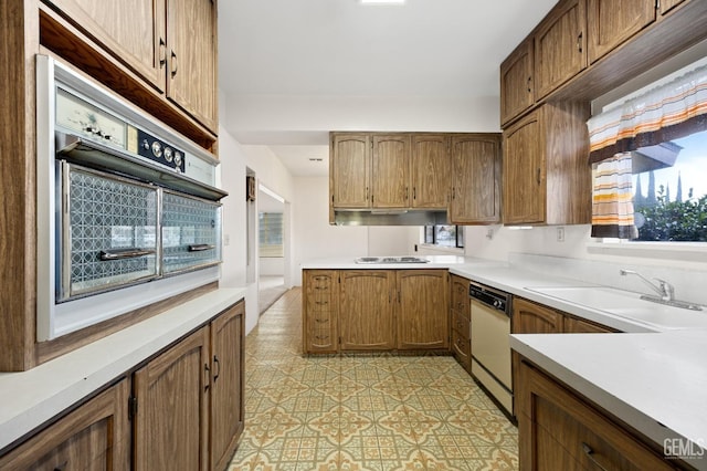 kitchen featuring dishwasher, oven, sink, and gas stovetop