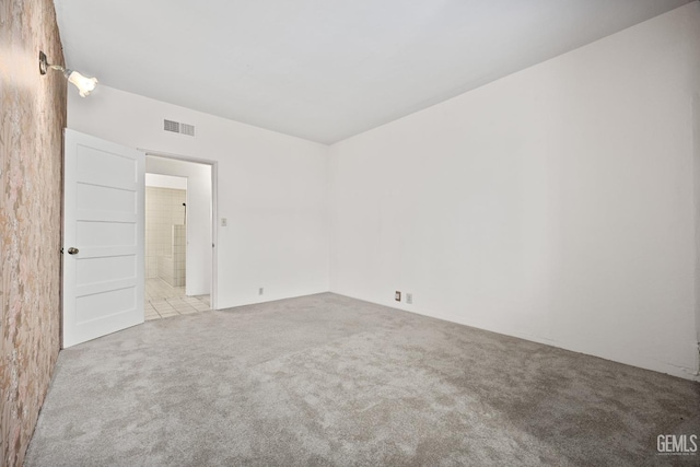 unfurnished room featuring light colored carpet