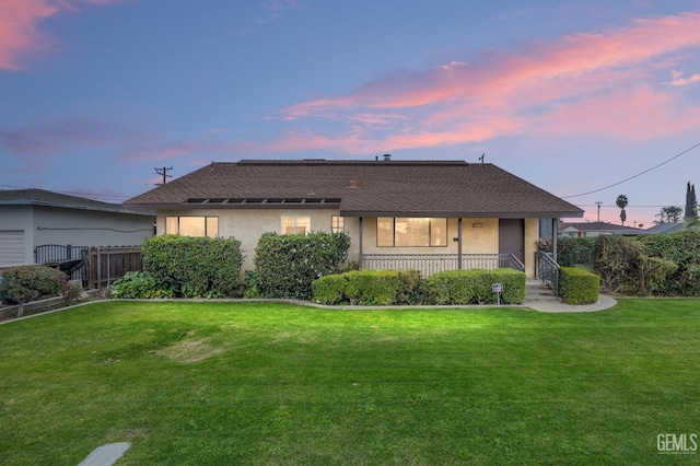 view of front of property featuring a lawn and covered porch