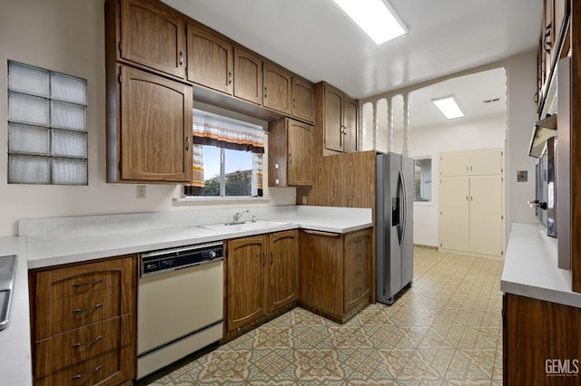 kitchen with stainless steel fridge, dishwasher, and sink