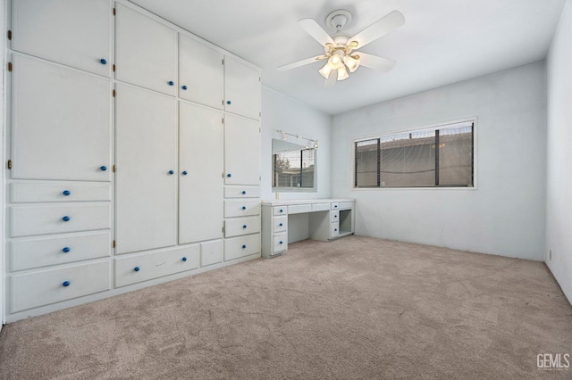 unfurnished bedroom with ceiling fan and light carpet