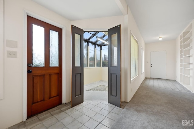 foyer entrance featuring light colored carpet