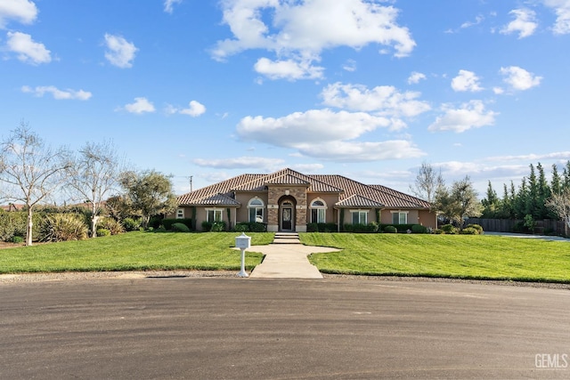 13765 Serrano Pl, Hanford, CA 93230 - mediterranean / spanish house with stucco siding, a tiled roof, and a front yard