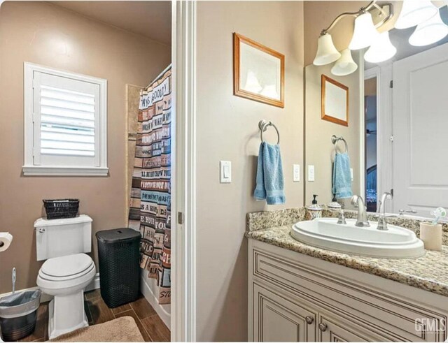 13765 Serrano Pl, Hanford, CA 93230 - bathroom with wood tiled floor, toilet, a shower with shower curtain, and vanity