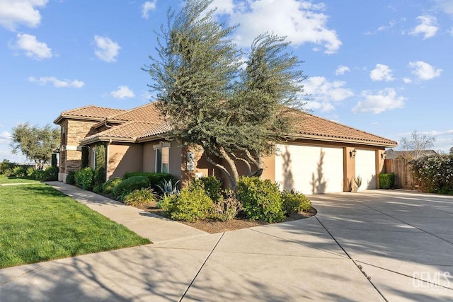 13765 Serrano Pl, Hanford, CA 93230 - view of side of property featuring a tile roof, concrete driveway, stucco siding, a garage, and a yard