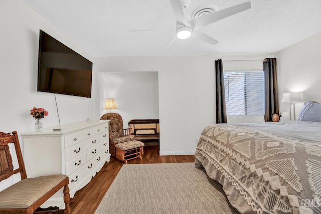 2316 Gosford Rd Unit R, Bakersfield, CA 93309 - bedroom with dark wood-type flooring, a textured ceiling, and ceiling fan
