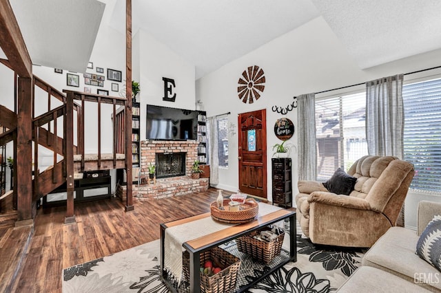 2316 Gosford Rd Unit R, Bakersfield, CA 93309 - living area with high vaulted ceiling, wood finished floors, plenty of natural light, stairway, and a brick fireplace