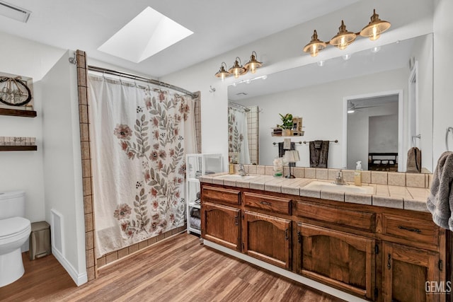 2316 Gosford Rd Unit R, Bakersfield, CA 93309 - full bath with wood finished floors, a skylight, and double vanity