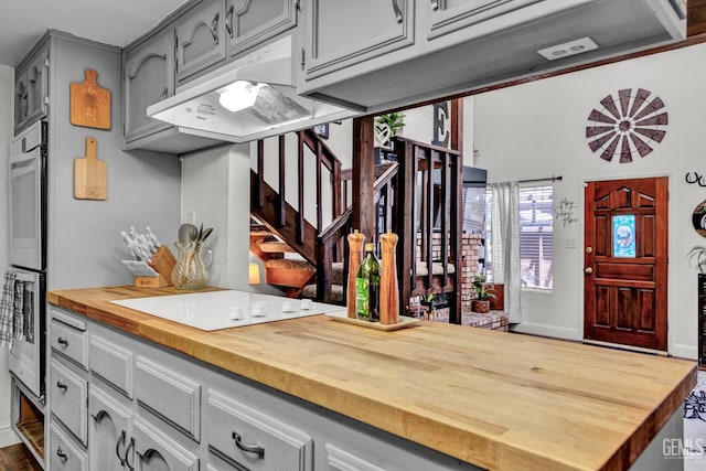 2316 Gosford Rd Unit R, Bakersfield, CA 93309 - kitchen with butcher block counters, under cabinet range hood, stovetop, gray cabinetry, and double oven