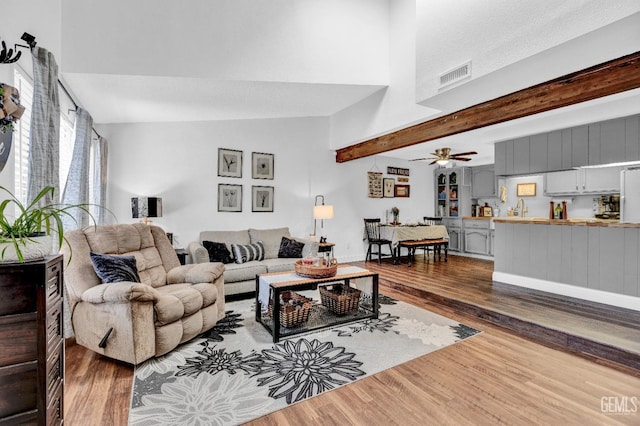 2316 Gosford Rd Unit R, Bakersfield, CA 93309 - living area with dark wood-type flooring, ceiling fan, and beamed ceiling