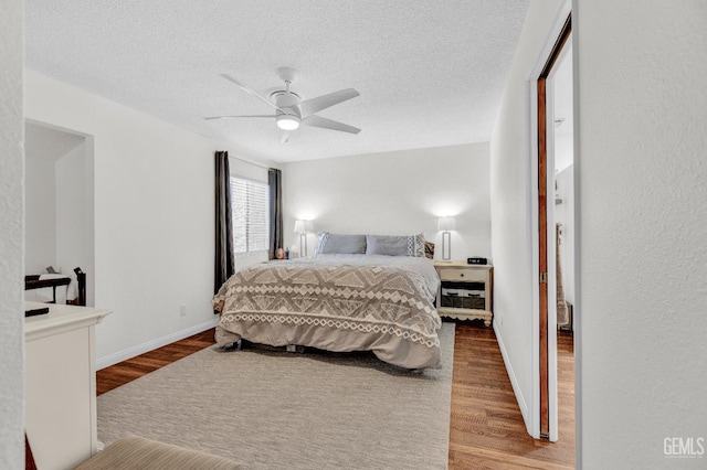 2316 Gosford Rd Unit R, Bakersfield, CA 93309 - bedroom featuring wood finished floors, a textured ceiling, and a ceiling fan