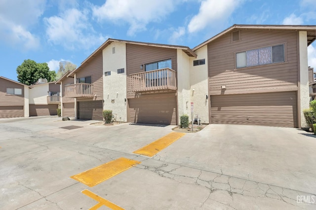 2316 Gosford Rd Unit R, Bakersfield, CA 93309 - view of front of home featuring a garage, driveway, and a balcony