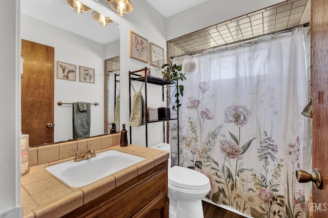 2316 Gosford Rd Unit R, Bakersfield, CA 93309 - full bathroom with vanity, wood finished floors, and a shower with shower curtain