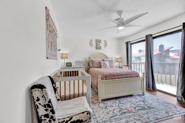 2316 Gosford Rd Unit R, Bakersfield, CA 93309 - bedroom featuring access to exterior, a textured ceiling, wood finished floors, and a ceiling fan