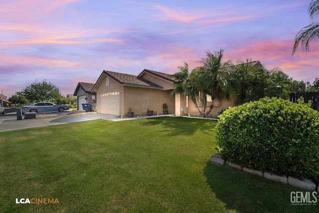 2119 Maganda Ave, Delano, CA 93215 - single story home with driveway, a lawn, stucco siding, and an attached garage