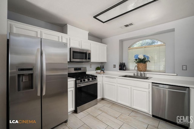 2119 Maganda Ave, Delano, CA 93215 - kitchen featuring appliances with stainless steel finishes, a sink, white cabinets, and light countertops