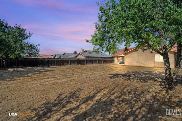 2119 Maganda Ave, Delano, CA 93215 - yard at dusk featuring a fenced backyard