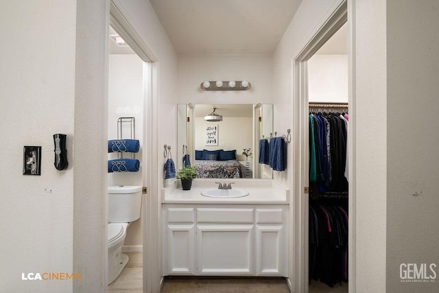 2119 Maganda Ave, Delano, CA 93215 - bathroom with toilet, vanity, ensuite bath, and a walk in closet