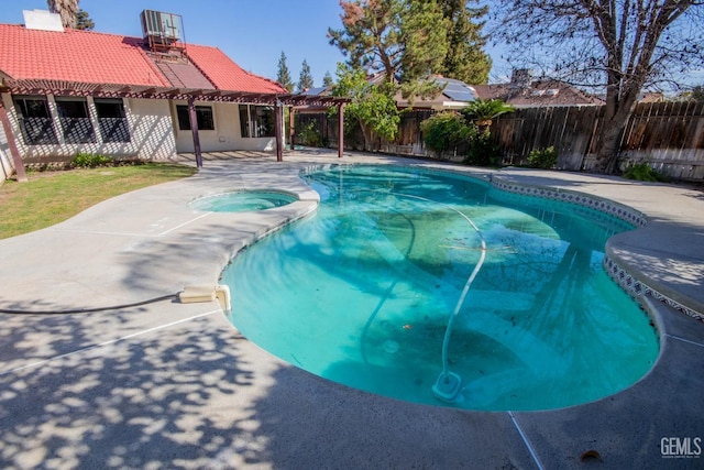 view of swimming pool featuring a fenced in pool, a patio, an in ground hot tub, and a fenced backyard