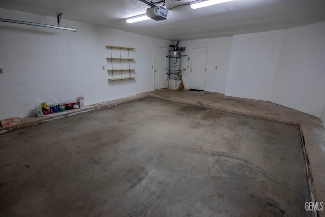 garage featuring strapped water heater and a garage door opener