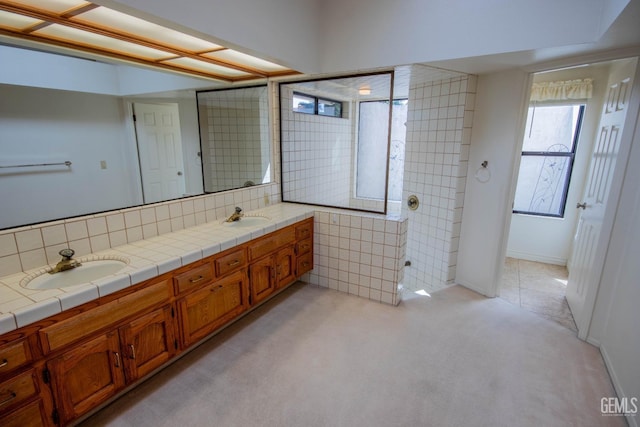 full bathroom featuring double vanity and a sink