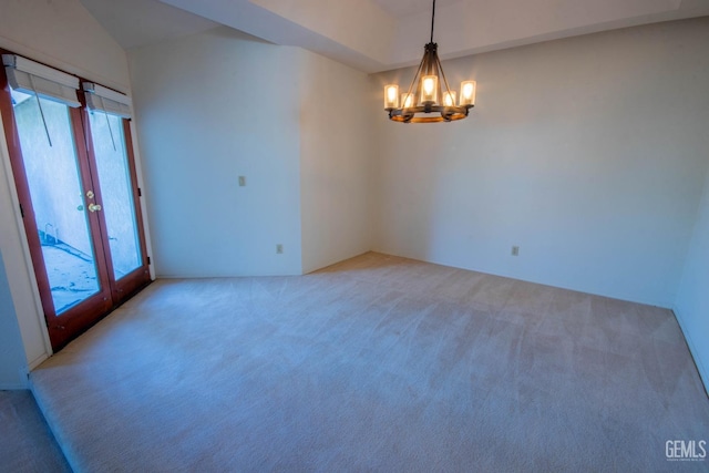 unfurnished room featuring light colored carpet, french doors, and an inviting chandelier