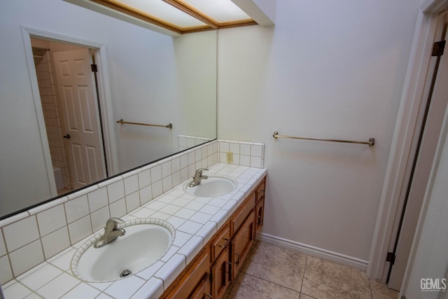 full bathroom featuring a sink, baseboards, tasteful backsplash, and double vanity