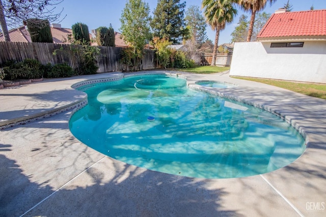 view of pool with an in ground hot tub, a fenced in pool, a patio, and a fenced backyard