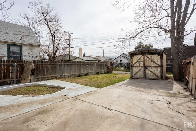 view of yard with a storage shed and a patio