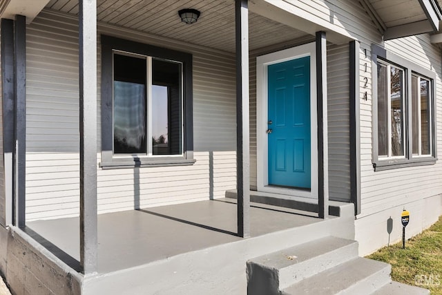 view of exterior entry with a porch