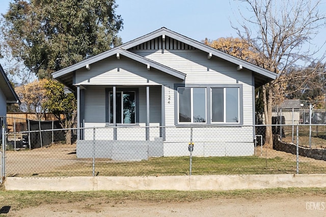 bungalow-style home featuring a front yard