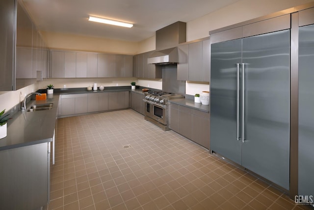 12820 Graham Ct, Bakersfield, CA 93311 - kitchen featuring high end appliances, dark countertops, light tile patterned flooring, and modern cabinets