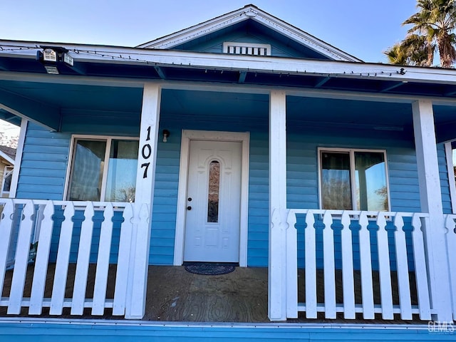 view of exterior entry featuring a porch