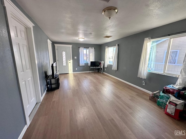 foyer with hardwood / wood-style flooring and a textured ceiling