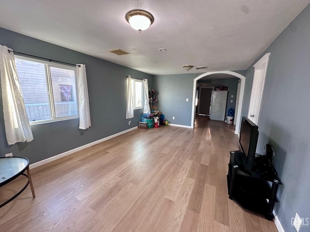 living room featuring wood-type flooring and a textured ceiling