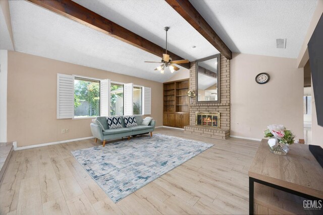 9408 Wandering Oak Dr, Bakersfield, CA 93311 - living area featuring a ceiling fan, baseboards, a textured ceiling, wood finished floors, and a fireplace