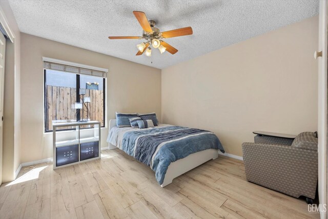 9408 Wandering Oak Dr, Bakersfield, CA 93311 - bedroom featuring wood finished floors, baseboards, a textured ceiling, and a ceiling fan