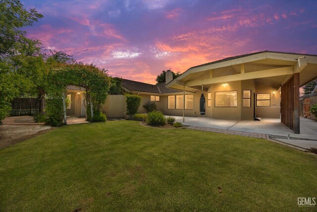 9408 Wandering Oak Dr, Bakersfield, CA 93311 - rear view of house featuring a chimney and stucco siding