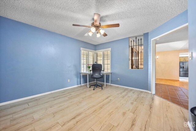 9408 Wandering Oak Dr, Bakersfield, CA 93311 - office space featuring a ceiling fan, wood finished floors, a textured ceiling, and baseboards