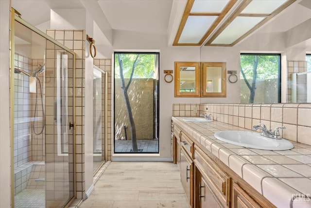 9408 Wandering Oak Dr, Bakersfield, CA 93311 - full bathroom featuring double vanity, a shower stall, decorative backsplash, and wood finished floors