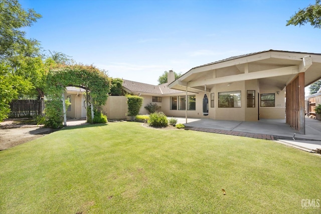 9408 Wandering Oak Dr, Bakersfield, CA 93311 - back of house with a chimney, a patio area, and stucco siding