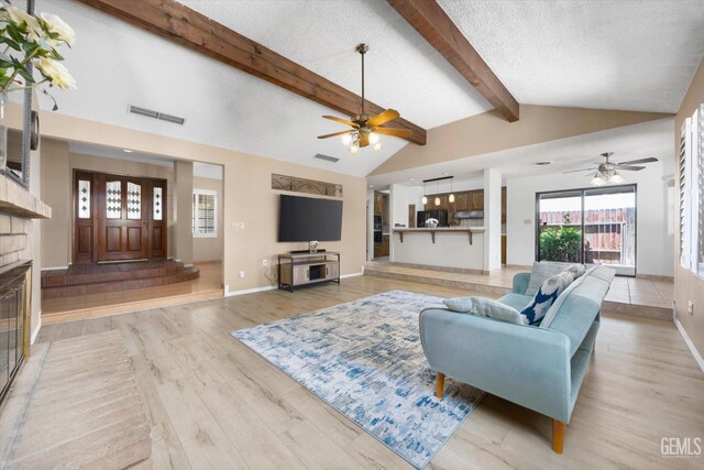9408 Wandering Oak Dr, Bakersfield, CA 93311 - living room with a ceiling fan, light wood-style floors, baseboards, and a textured ceiling