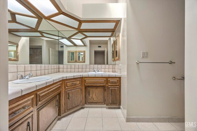 9408 Wandering Oak Dr, Bakersfield, CA 93311 - bathroom featuring double vanity, tile patterned floors, backsplash, and baseboards