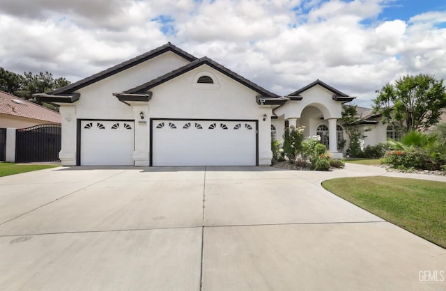 10505 Finchley Dr, Bakersfield, CA 93311 - single story home with driveway, an attached garage, stucco siding, a gate, and a front lawn