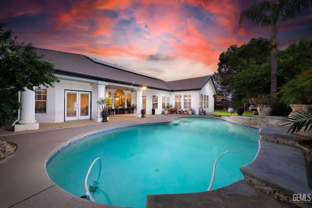10505 Finchley Dr, Bakersfield, CA 93311 - pool at dusk with french doors, a patio, and an outdoor pool