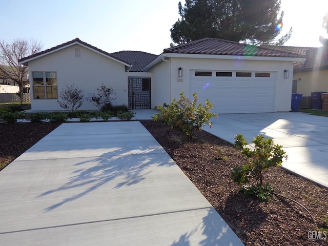 single story home featuring a garage, stucco siding, driveway, and a tiled roof