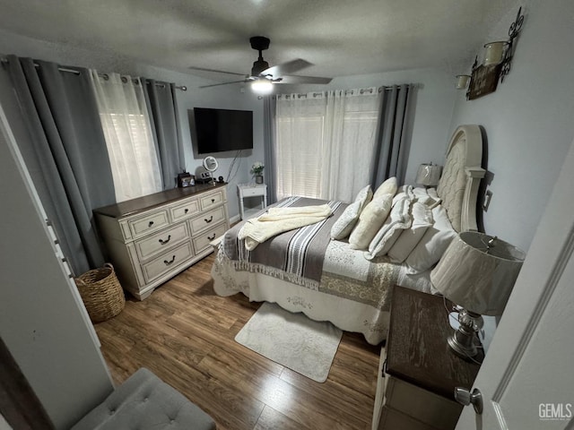 bedroom with wood finished floors and a ceiling fan
