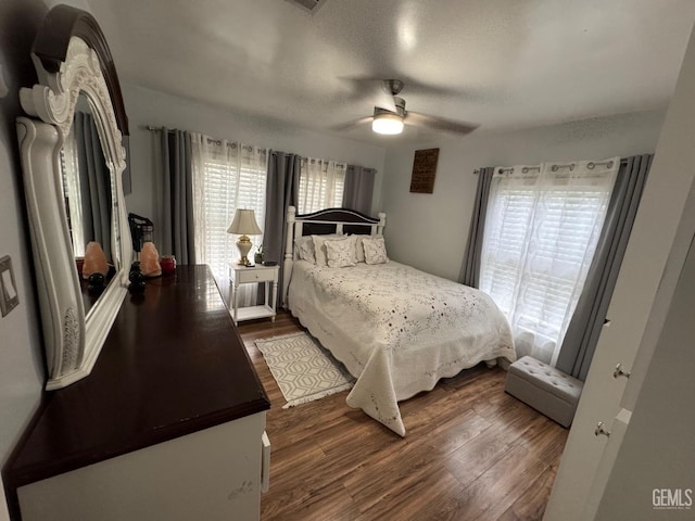 bedroom with dark wood-style flooring and ceiling fan