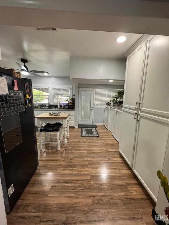 interior space with recessed lighting, dark wood-style flooring, and visible vents